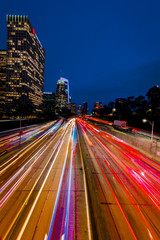 Fototapeta na wymiar JANUARY 20, 2019, LOS ANGELES, CA, USA - California 110 South leads to downtown Los Angeles with streaked car lights at sunset