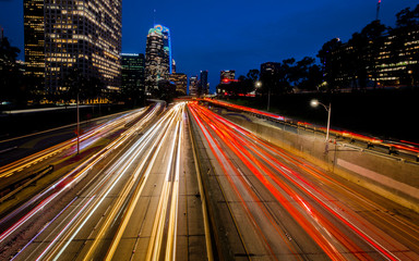 Fototapeta na wymiar JANUARY 20, 2019, LOS ANGELES, CA, USA - California 110 South leads to downtown Los Angeles with streaked car lights at sunset