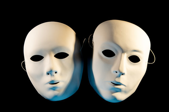 white masks of man and woman on a black background