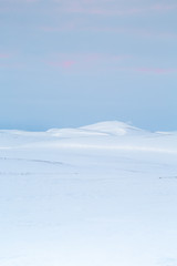 Icelandic hills with snow during sunset 