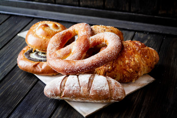 Various baked products on dark wooden rustic background