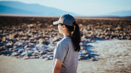 Asian girl walking in the badwater basin in the Death Valley, California, USA