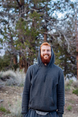 Naklejka premium Red hair male model in a hoodie smiling towards the Camera, Big Bear Lake, USA