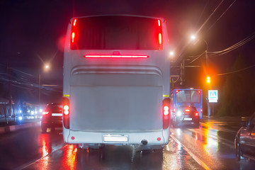 bus moves at night in the rain on a city