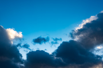 Naklejka na ściany i meble Blue sky with black clouds