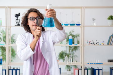 Funny male chemist working in the lab