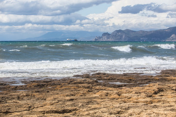 landscape seaside storm ships on the horizon and rocks
