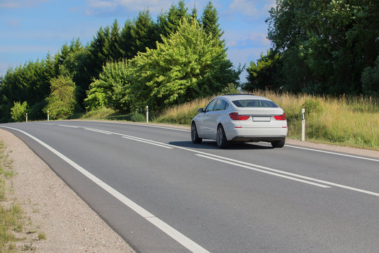 car moves on a country road in summer