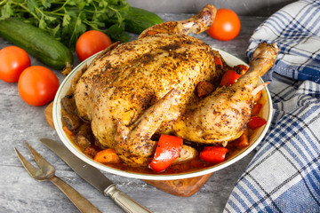 Baked chicken with vegetables on a plate.