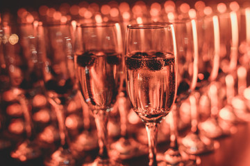 View of alcohol setting on catering banquet table, row line of different colored alcohol cocktails on a party, martini, vodka, and others on decorated catering bouquet table event