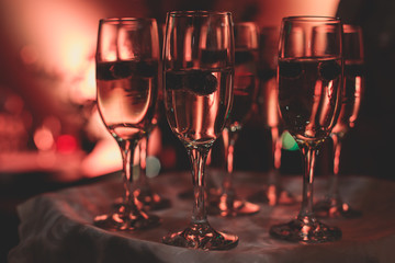 View of alcohol setting on catering banquet table, row line of different colored alcohol cocktails on a party, martini, vodka, and others on decorated catering bouquet table event