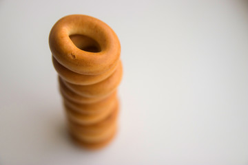 many bagels stacked on top of each other on a white kitchen table close-up