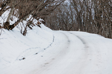dangerous snow-covered turn of the road on the mountainside. icy condition