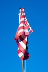 A torn twisted neglected American Flag