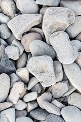 Background with marine pebble stones on the seaside.