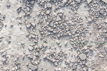 Horizontal background. Finely crumbled concrete. Small stones on a concrete surface.
