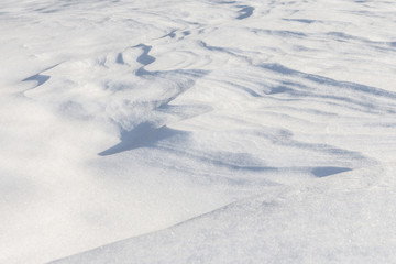 Fototapeta na wymiar Background of smooth surface of snow, snow waves