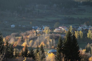 Autumn mountain forest village landscape. Mountain village in autumn.