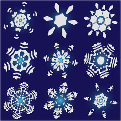 Set of isolated falling snowflakes on blue background.