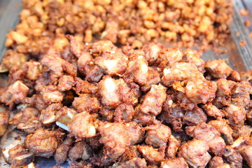 Traditional Thai food at market. Roasted spicy pork