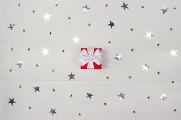 A red gift box with a white bow.