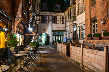 Exterior of a european restaurant in the narrow street at night