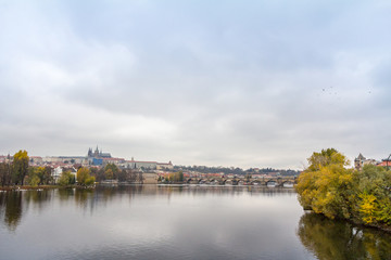 Fototapeta na wymiar Panorama of the Old Town of Prague, Czech Republic, with a focus on Charles bridge (Karluv Most) and the Prague Castle (Prazsky hrad) seen from the Vltava river. It is the main touristic landmark 