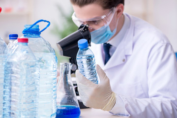 Young male chemist experimenting in lab