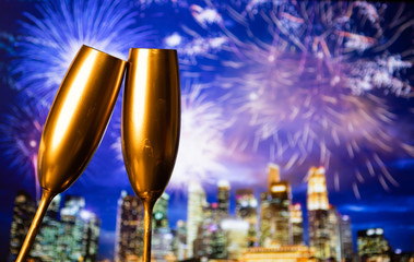 golden champagne glasses and fireworks  new year in Singapore