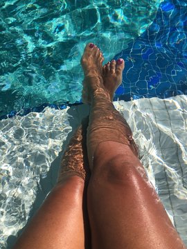 Woman Legs In The Pool