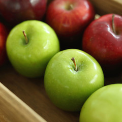 red and green apple fruit in harvest wood basket