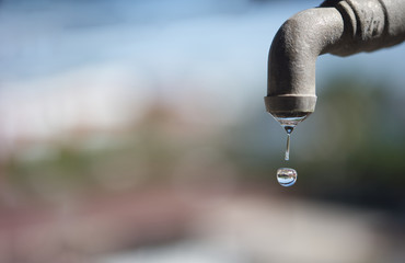 saving water concept.Close up with dripping water-drop.