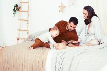 Obraz na płótnie Canvas young happy family together having fun in bed, lifestyle people concept