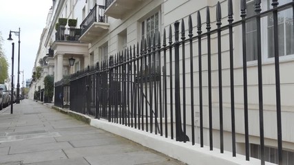 A metal fence surrounding a terraced house in London.