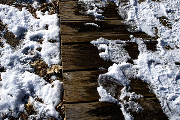 Snow melting on boardwalk