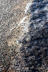 Frozen pebbles on the beach in the winter