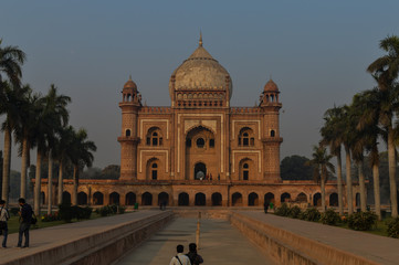 Fototapeta na wymiar A bunch of photography students standing and taking picture in-front of safdarjung tomb memorial at winter morning.