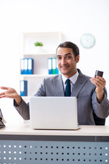 Young male accountant working in the office