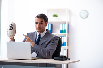 Young male accountant working in the office