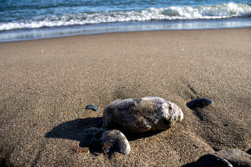 Frozen shapes of rock and sand in the beach in the winter