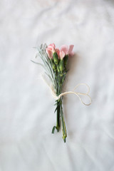 simple bouquet of delicate pastel tulips on white satin