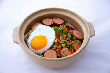 Spanish dish pisto manchego with chorizo sausages and fried egg