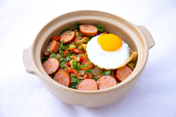 Spanish dish pisto manchego with chorizo sausages and fried egg