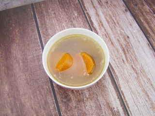 Chinese tableware carrot stew chicken soup on wooden board