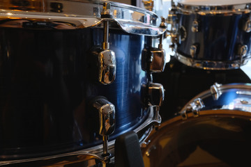 Side view of snare with blured bassdrum and tom, Drumset is it a instruments for drummer musician, percussion rythm equipment. with selective focus