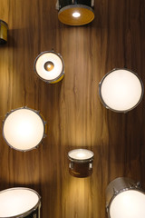 beautiful lamp for decoration in the house, craft from snare and drums frame, wood texture wall, yellow light  