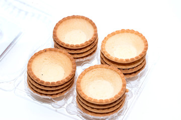Empty tartlets on a white background for a festive buffet reception. The concept of cooking.