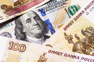 One hundred dollars surrounded by Russian rubles, close-up