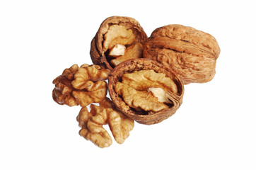 Walnut kernels and shell nuts on a wooden table. Close-up. Isolated on white.