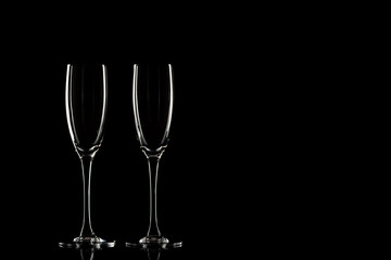 Empty champagne glasses on a black background